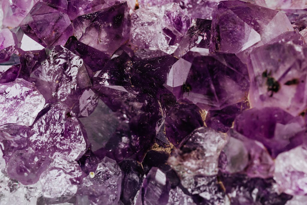 Macro shot of natural purple amethyst crystals showcasing their vibrant hues and intricate formations.